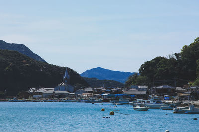 Scenic view of sea and buildings against sky