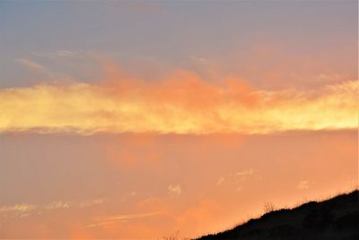 Low angle view of dramatic sky during sunset