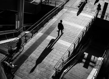 High angle view of people walking on staircase in city
