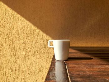 High angle view of coffee on table against wall