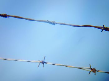 Low angle view of barbed wire