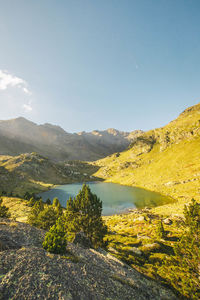 Scenic view of lake and mountains against sky