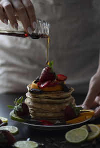 Midsection of woman preparing cake