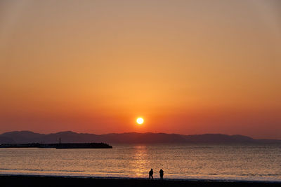 Scenic view of sea against orange sky