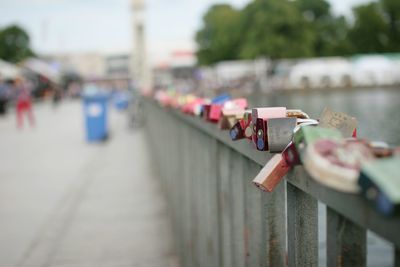 Close-up of padlocks on railing in city