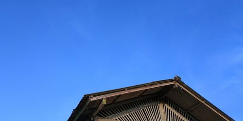 Low angle view of old building against clear blue sky