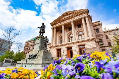 Low angle view of statue of flowering plants