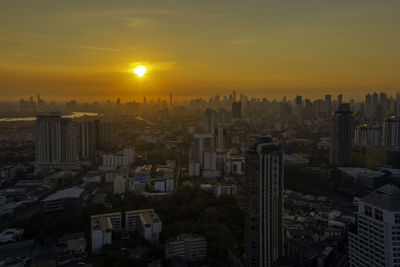 High angle view of modern buildings against sky during sunset