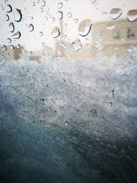 Close-up of water drops against sky