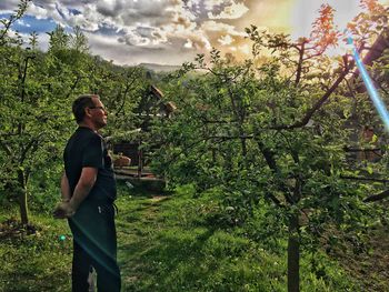 Man standing by plants against sky