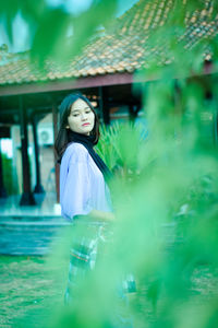 Young woman standing infront of traditional house of yogyakarta