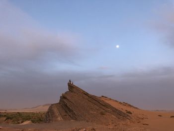 Scenic view of desert against sky at dusk