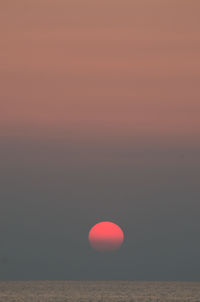 Scenic view of sea against orange sky