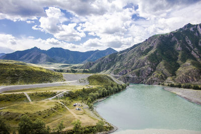 Scenic view of lake and mountains against sky