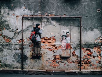 Full length of old man standing on wall