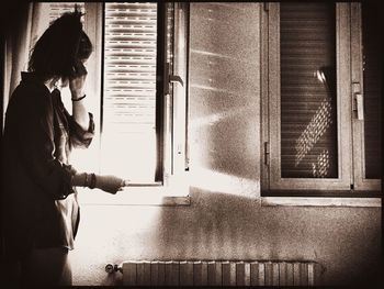 Woman looking through window