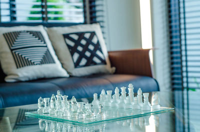 Close-up of chess pieces on board at home