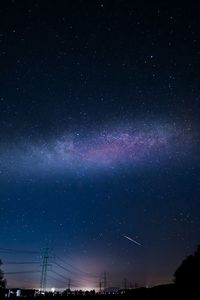 Low angle view of silhouette trees against sky at night