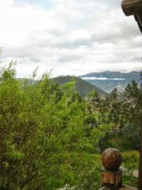 Scenic view of mountains against cloudy sky