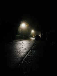 Cars on illuminated street at night