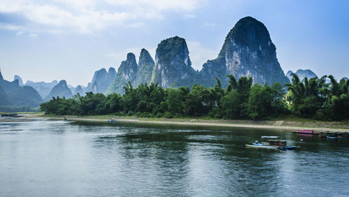 Scenic view of lake and mountains against sky