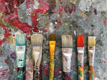 Directly above shot of paintbrushes on table