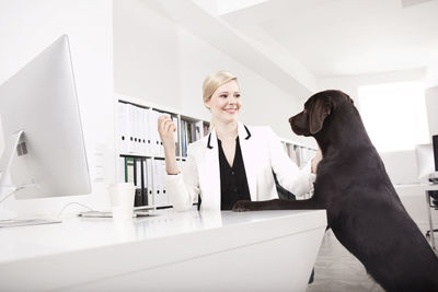 Business woman with her labrador retriever in the office