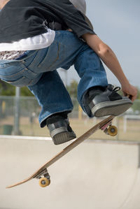 Low section of man skateboarding