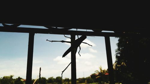 Low angle view of silhouette column against sky