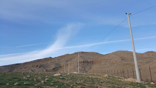 Low angle view of mountain against blue sky