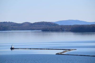 Calm lake with mountains in background