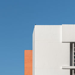 Low angle view of building against clear blue sky