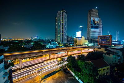 Light trails on road in city at night