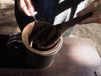 Midsection of person preparing food on table