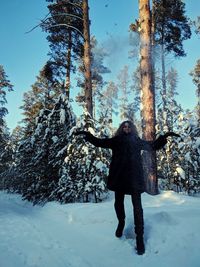 Full length of woman standing on snow covered land