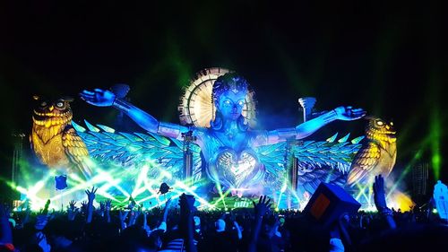 Group of people at illuminated street light at night