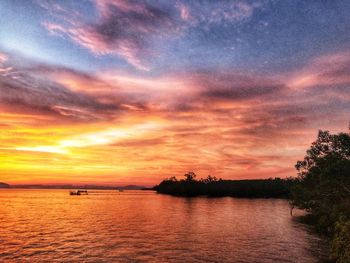 Scenic view of sea against romantic sky at sunset