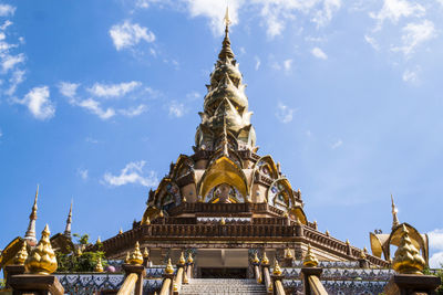 Low angle view of statue against temple building against sky