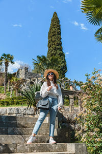 Full length of woman standing against sky