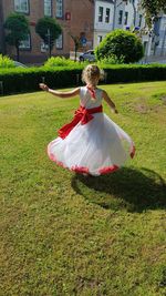 Rear view of boy dancing in park