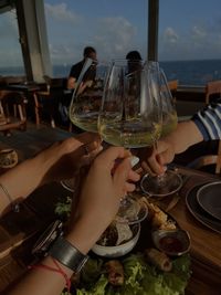 Midsection of woman holding wineglass