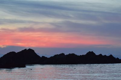 Scenic view of sea and mountains during sunset