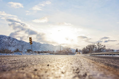 Empty road against sky during winter