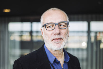 Mature businessman standing at workplace