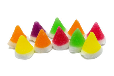 Close-up of multi colored candies against white background