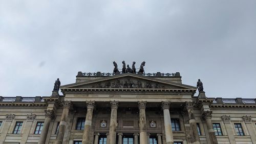 Low angle view of historical building against cloudy sky