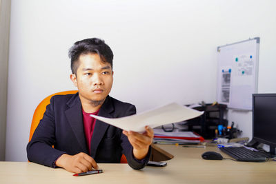 Portrait of man working on table