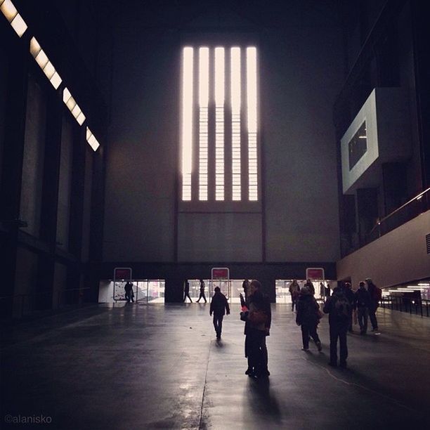 indoors, architecture, built structure, illuminated, person, men, walking, large group of people, city life, lifestyles, railroad station, building, building exterior, the way forward, flooring, modern, city, corridor, ceiling