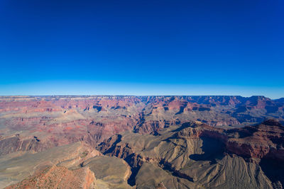 Scenic view of mountains against clear blue sky