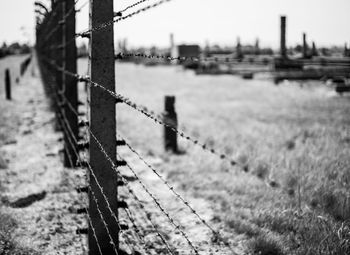 Barbed wire fence on field